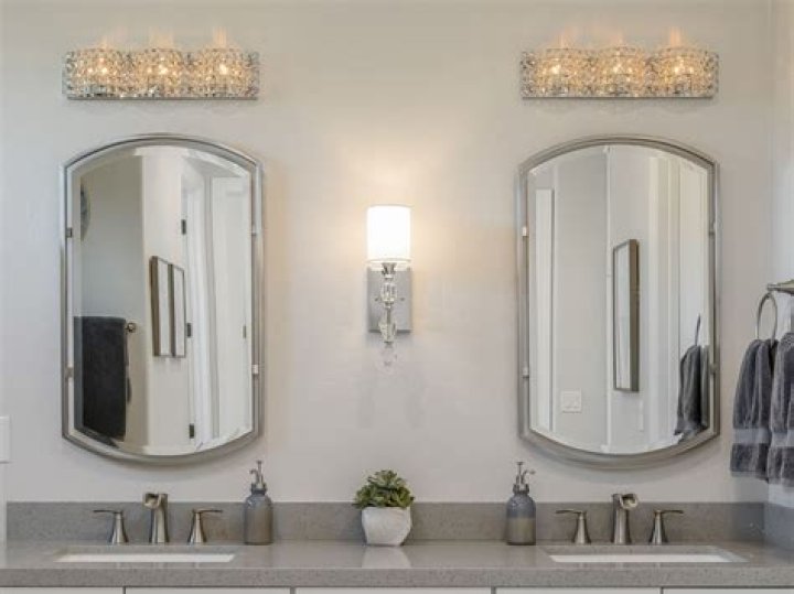 Can a bathroom mirror be bigger than vanity